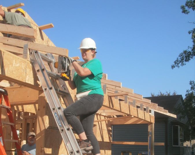 Butenas sawing wood. 